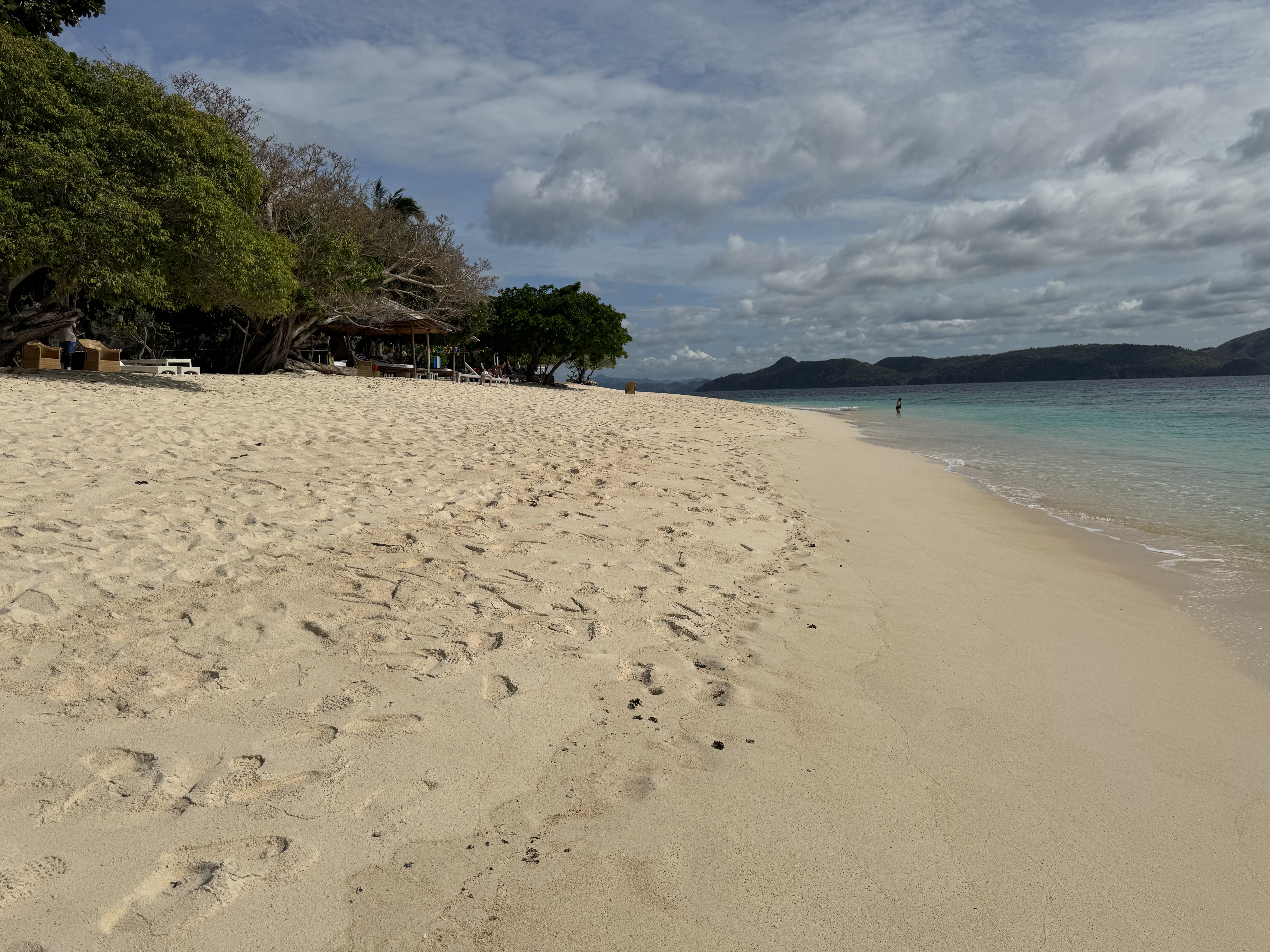 A wide stretch of beach and tropical coastline.