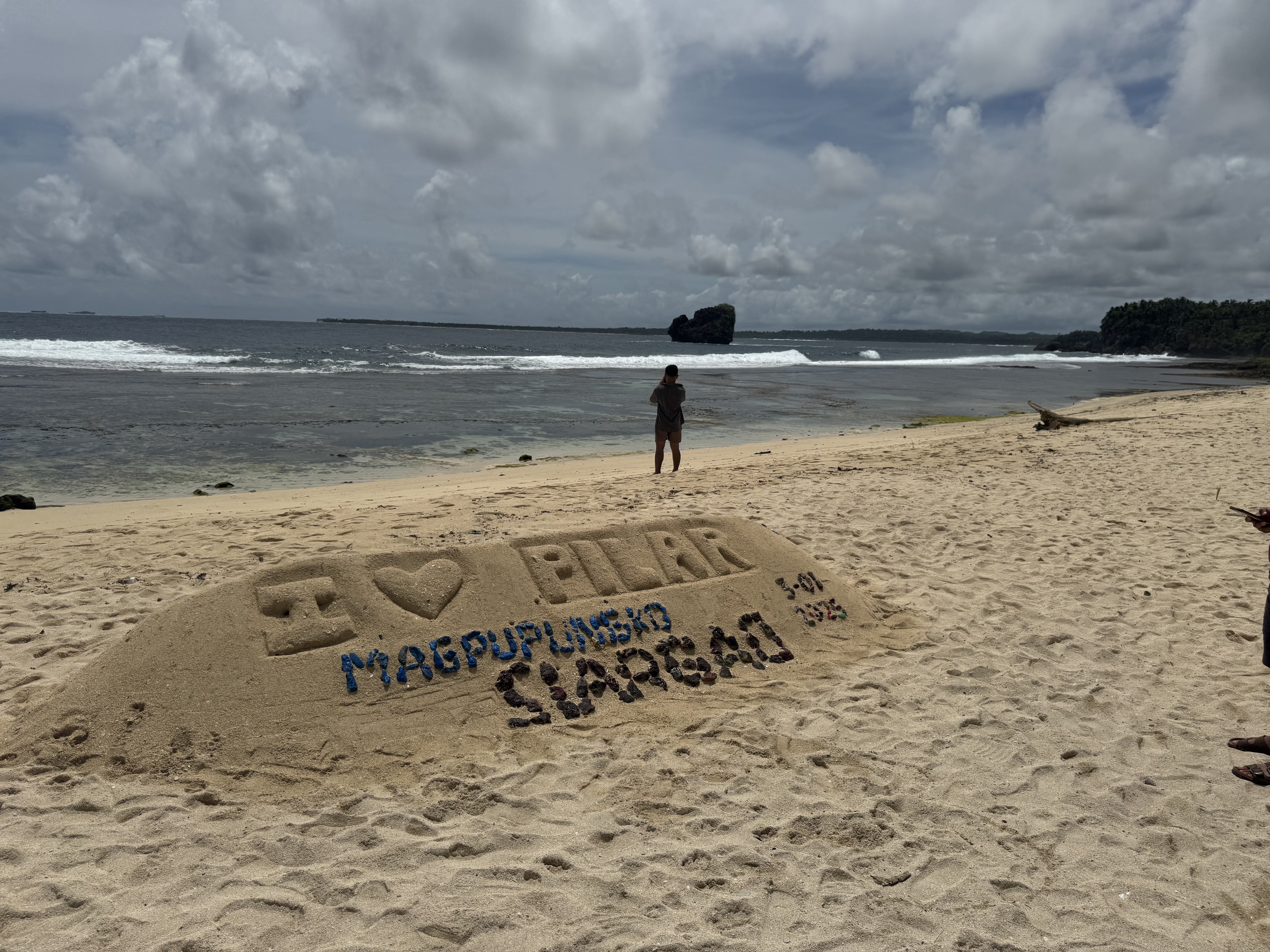 A beach message in the sand on Siargao.