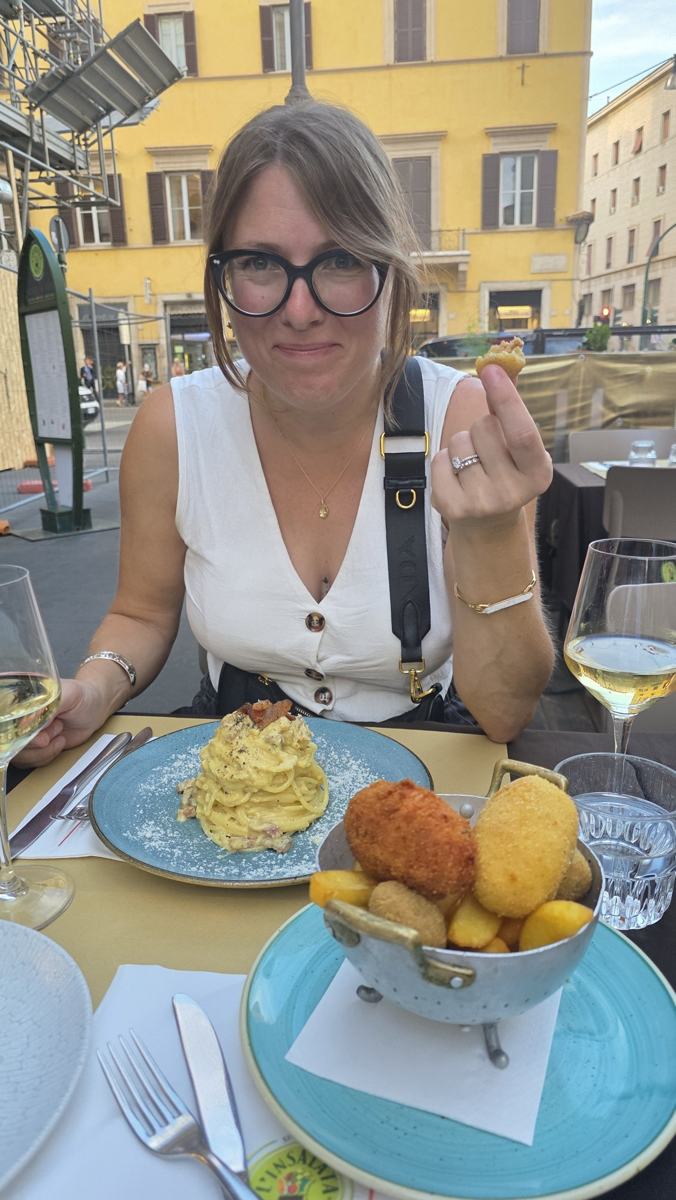 Pasta, wine and a table outside in Rome.