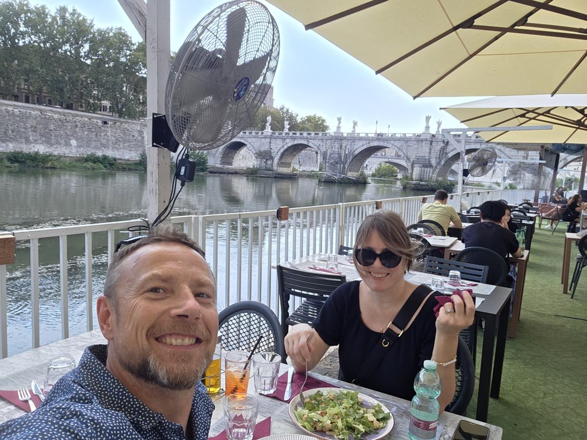 Lunch beside the Tiber, with the bridge just beyond our table.