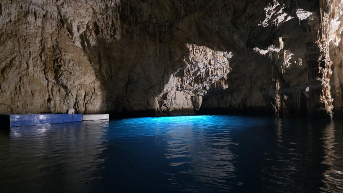 Blue-green light inside the Emerald Grotto.