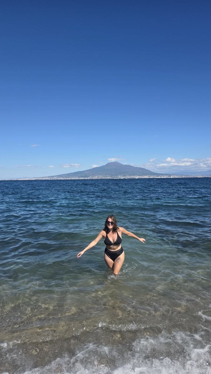 Jenn in the water during our Seiano beach stop, with Vesuvius across the bay.