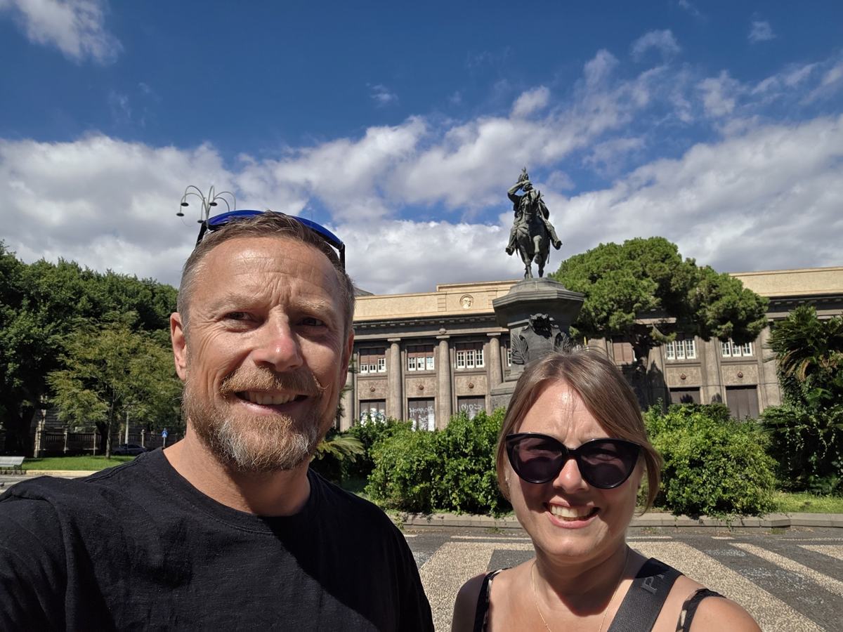 A pause beside a monument while exploring Catania.