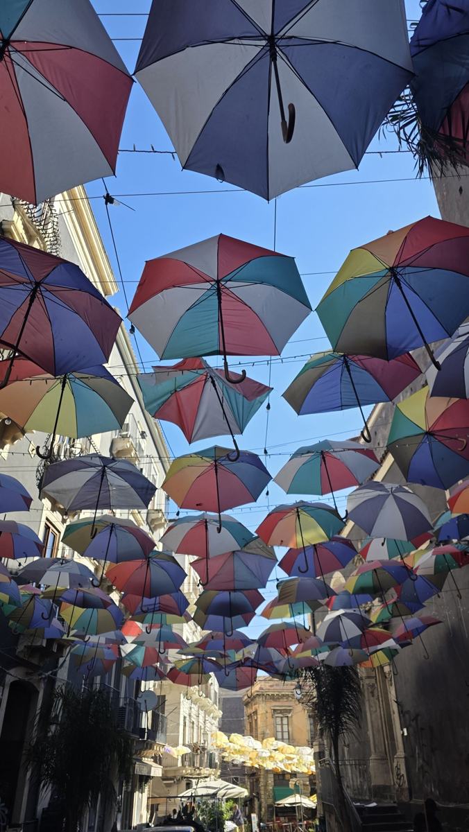 Colourful umbrellas above a Catania street.