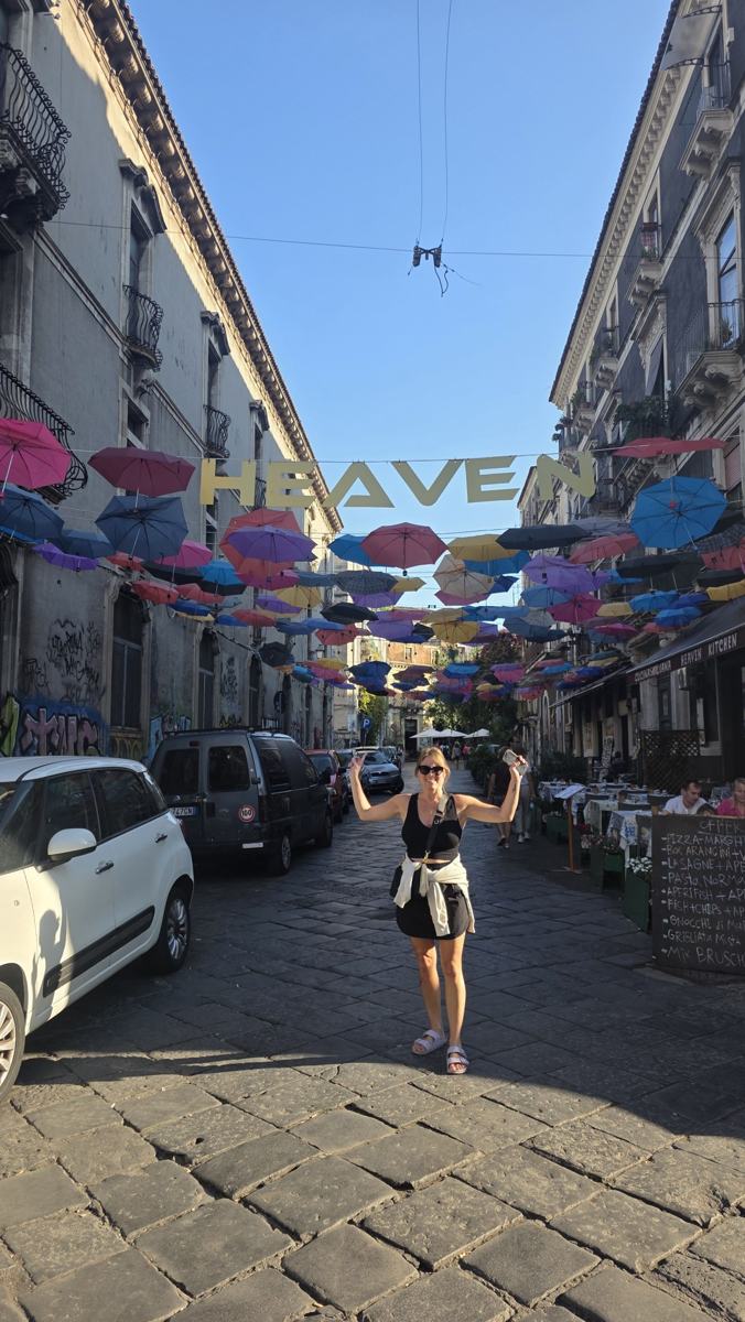 Jenn beneath the umbrellas.