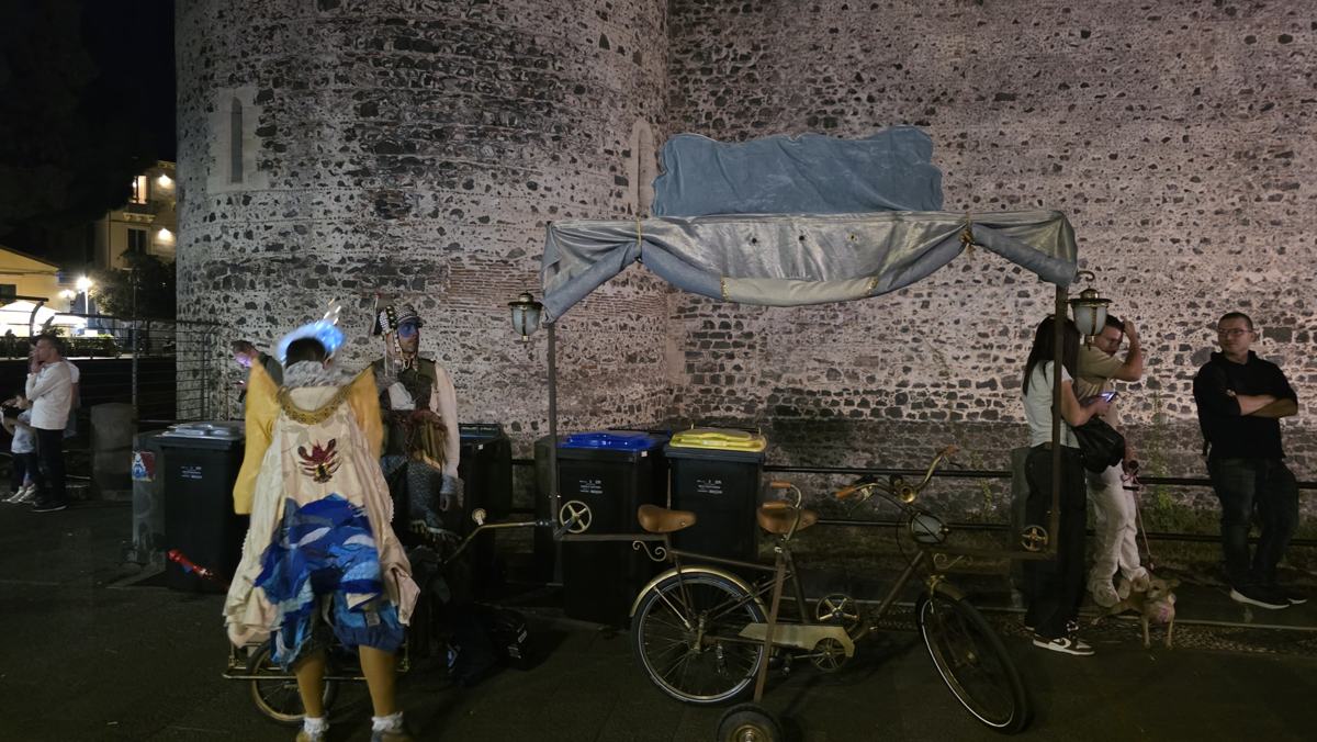 A performer beside the castle after dark.
