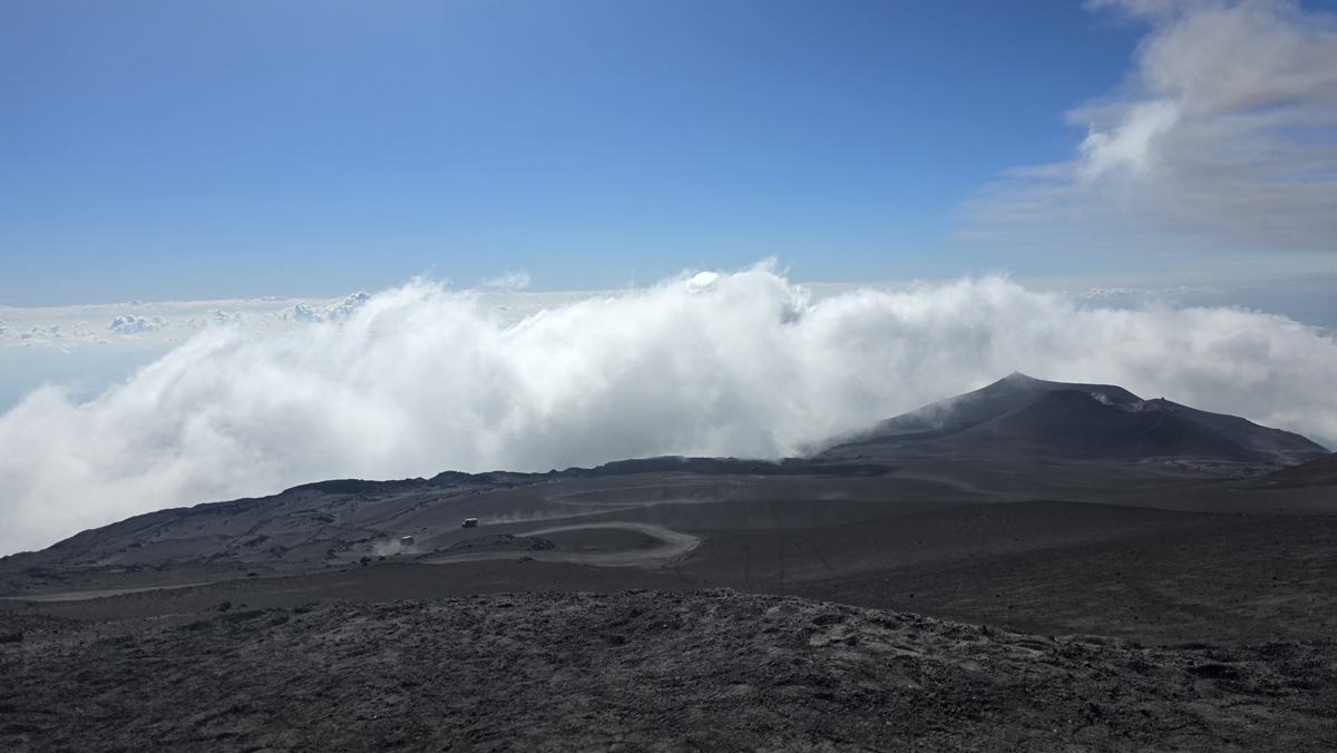 Etna’s volcanic landscape above the clouds.