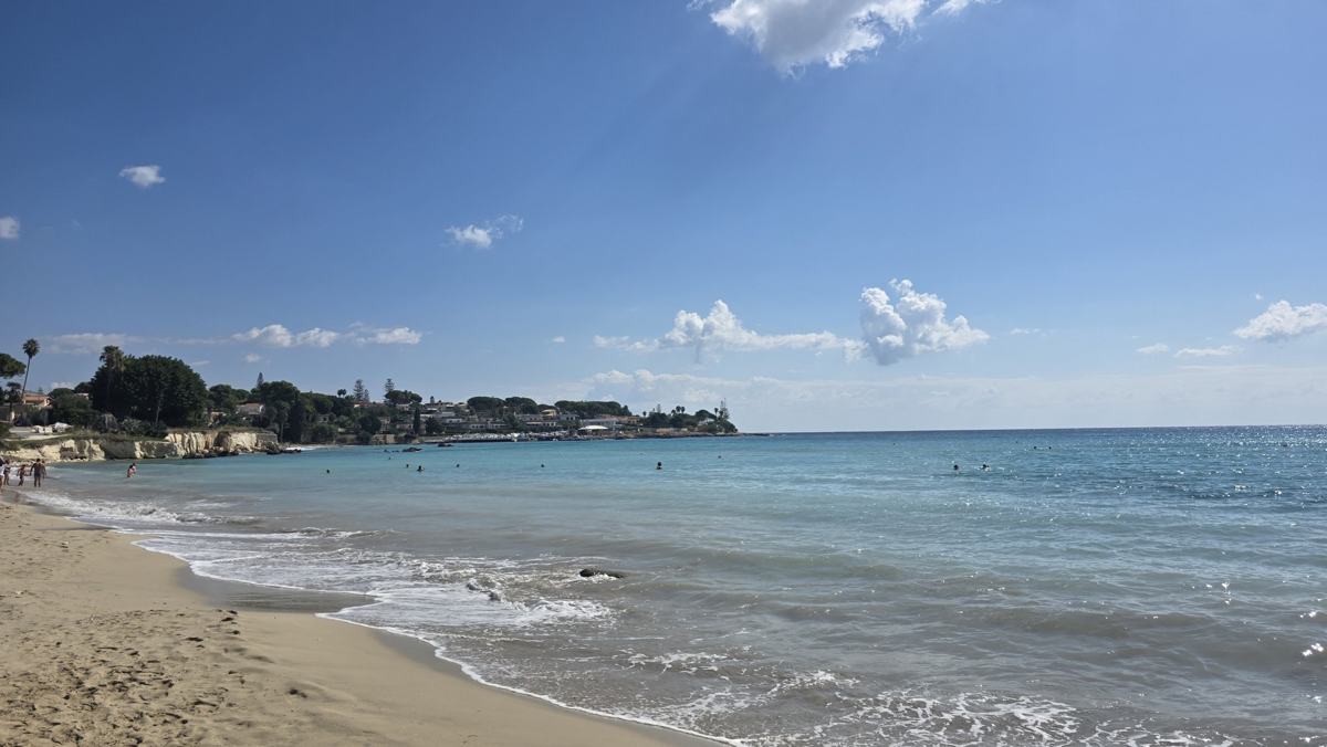 Sand and calm water on the last beach day.