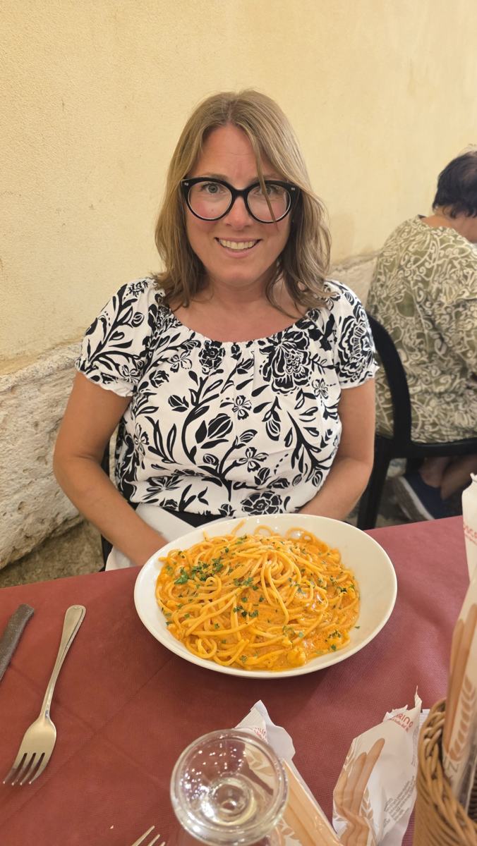 Jenn with a plate of pasta at our final dinner.